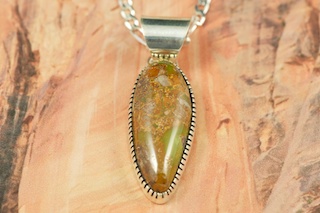 Genuine Crow Springs Turquoise set in Sterling Silver Pendant. Created by Navajo Artist Jeff Largo.  The Crow Springs Mine is located near Tonopah, Nevada. Free 18 inch Sterling Silver Chain with purchase. 